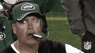 Man In Jets Hat And Headphones Looking At Camera GIF