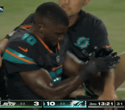 Man In Jets Jersey Helped Off Field GIF