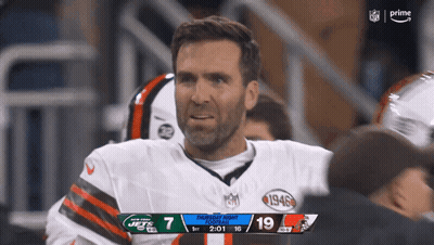 Man In Jets Jersey Looks At Camera GIF