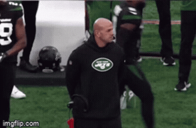 Man In Jets Sweatshirt Standing On Field GIF