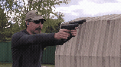 Man In John Deere Hat Holding Two Guns GIF