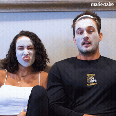Man In Jupiter Warriors Shirt Beside Masked Woman GIF