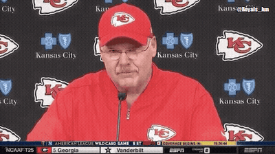 Man In Kansas City Hat Standing In Front Of Wall GIF
