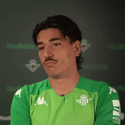 Man In Kappa Shirt Sitting At Table With Hands Folded GIF