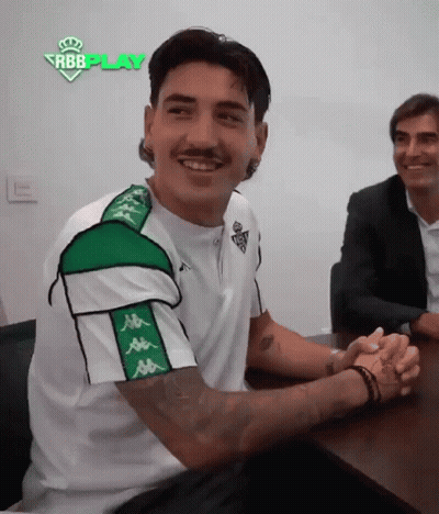 Man In Kappa Shirt Sitting With Hands Folded GIF