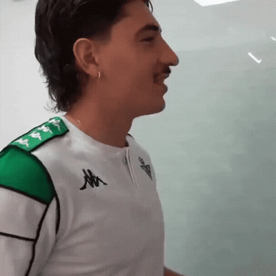 Man In Kappa Shirt Walking With Masked Man GIF