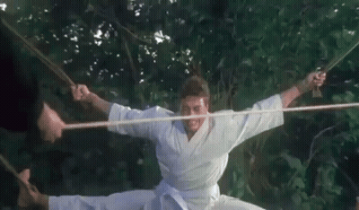 Man In Karate Uniform Doing Split With Rope GIF