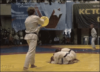 Man In Karate Uniform Holding Yellow Frisbee With ICT Sign GIF