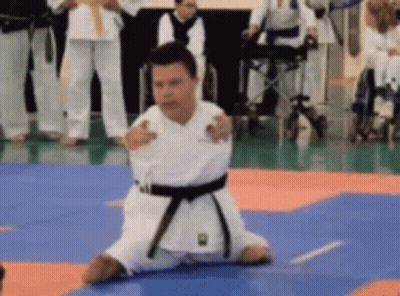 Man In Karate Uniform Kneeling GIF