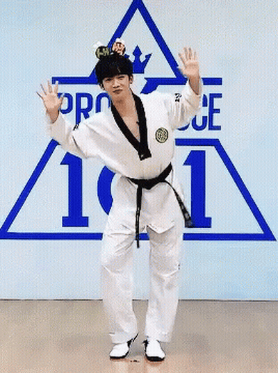 Man In Karate Uniform Standing On One Leg In Front Of Pro 101 Sign GIF