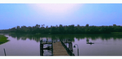 Man In Kayak Floating Near Dock GIF