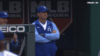 Man In KC Hat Stands In Dugout With Arms Crossed GIF
