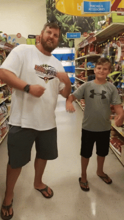 Man In Kid's Pro Shirt Next To Boy GIF