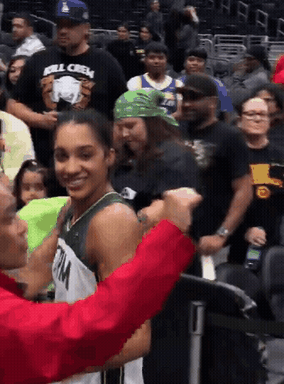 Man In Kill Crew Shirt Talking To Girl In Basketball Uniform GIF