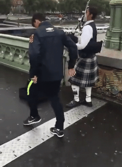Man In Kilt Holding Hands With Man In Rugby Jacket GIF