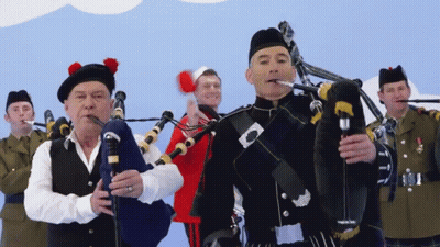 Man In Kilt Playing Bagpipe For Group Of Men GIF