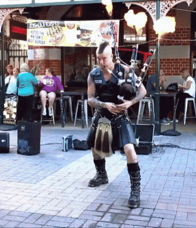 Man In Kilt Playing Bagpipes With Biscuits Sign GIF