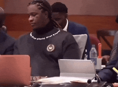 Man In Kings Reigning Sweater Sitting At Laptop GIF