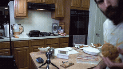 Man In Kitchen Eating Fried Chicken Sandwich GIF