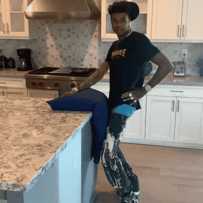 Man In Kitchen Wearing Black Shirt Saying Smoke GIF