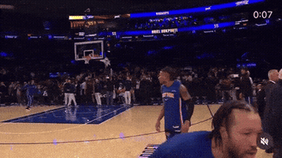 Man In Knicks Jersey On Basketball Court With Crowd GIF