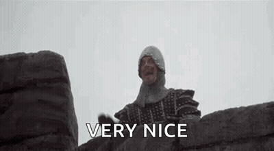 Man In Knight Helmet Standing On Stone Wall GIF