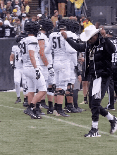 Man In Knights Shirt Stands Before Crowd GIF