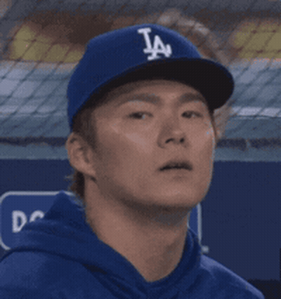 Man In LA Dodgers Hat Looks At Something GIF