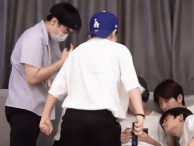 Man In LA Dodgers Hat Next To Another Man GIF