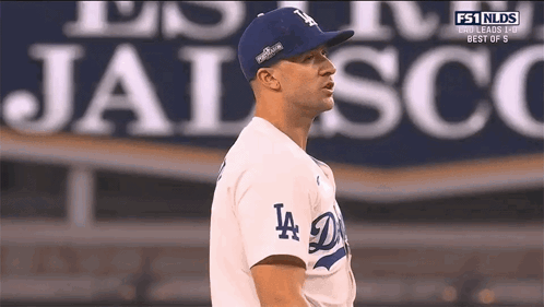 Man In LA Dodgers Jersey In Front Of Jalisco Sign GIF