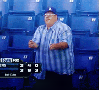 Man In LA Hat In Front Of Scoreboard GIF