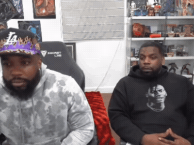 Man In LA Hat Next To Man In Black Hoodie GIF