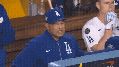 Man in LA Hat Sitting in Dugout