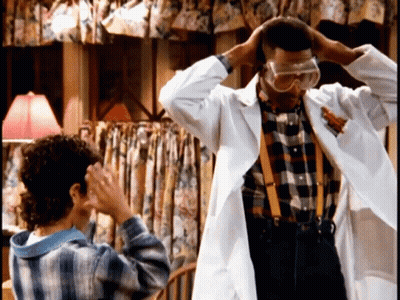 Man In Lab Coat And Goggles Next To Girl GIF