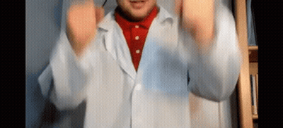 Man In Lab Coat And Red Shirt Making Funny Face GIF