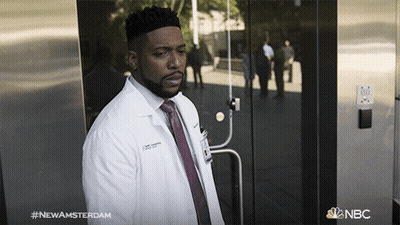 Man In Lab Coat And Tie With NBC Logo GIF