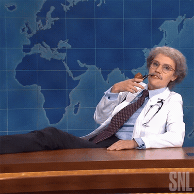 Man In Lab Coat At Desk With SNL Logo GIF