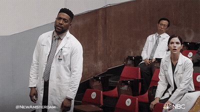 Man In Lab Coat In Front Of Red Seats #NewAmsterdam GIF