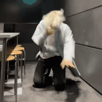 Man In Lab Coat Kneeling In Dark Room GIF