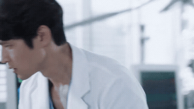 Man In Lab Coat Looking Down GIF