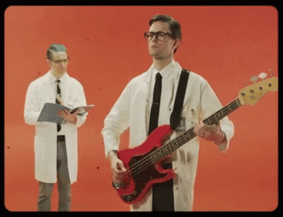 Man In Lab Coat Playing Red Bass Guitar GIF