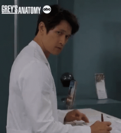 Man In Lab Coat Sitting At Desk With Grey's Anatomy ABC GIF
