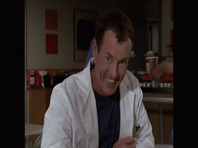 Man In Lab Coat Smiling With Cell Phone GIF