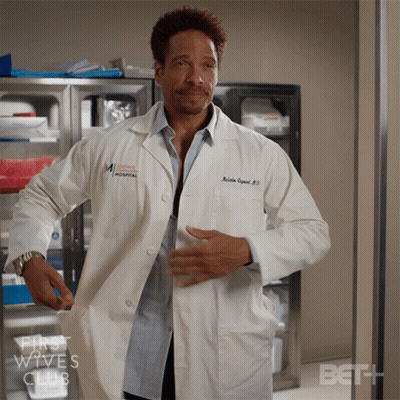 Man In Lab Coat Standing Before Bet Sign GIF