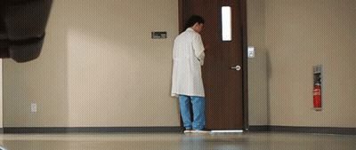 Man In Lab Coat Standing In Front Of Hospital Door GIF