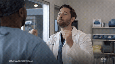 Man In Lab Coat Talking To Man In Scrubs #NewAmsterdam GIF