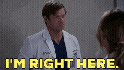 Man In Lab Coat Talking To Woman In Hospital Room GIF