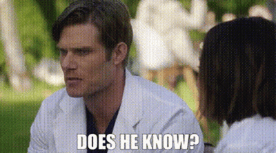 Man In Lab Coat Talking To Woman In Park GIF