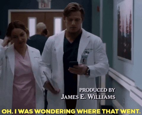 Man In Lab Coat Walking With Nurse In Hospital Hallway GIF