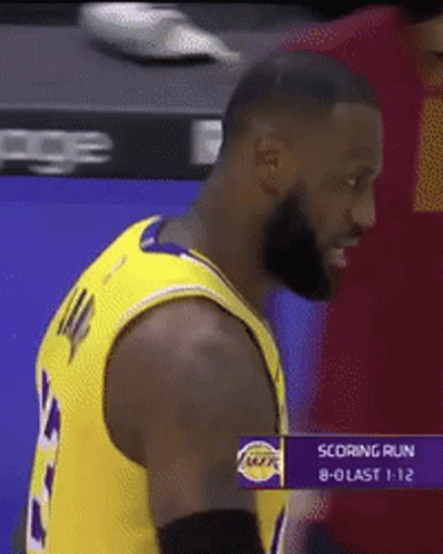 Man in Lakers Jersey Standing in Front of Scoring Run Screen